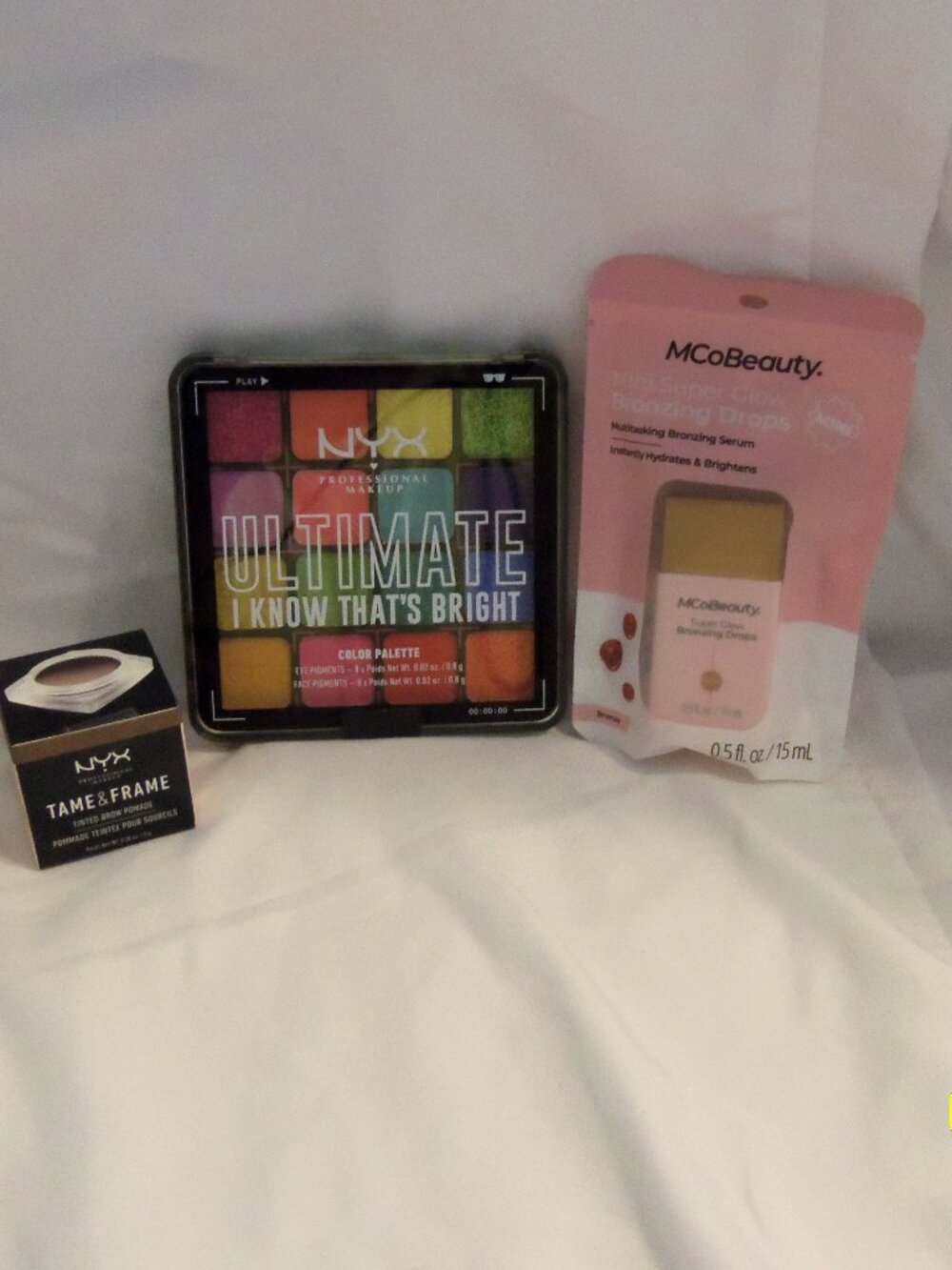 NYX Ultimate Shadow Palette, NYX Tinted Brow Pomade and MCoBeauty Bronzing Drops